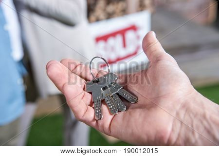 Cropped View Of Saleman Holding Keys Of New House, House For Sale Concept