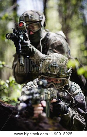 Photo of soldiers on reconnaissance in woods during day