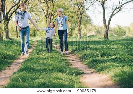 happy young family have fun in prak while walking