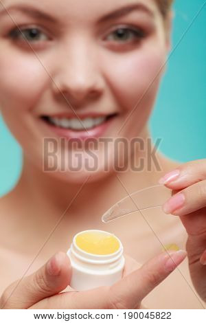 Female putting applying lip balm moisturizing balsam. Girl taking care of lips. Skincare.