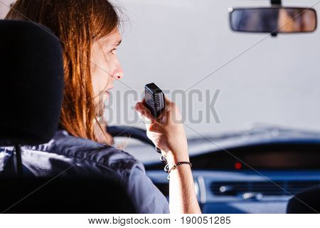 Young Man Driving Car Using Cb Radio