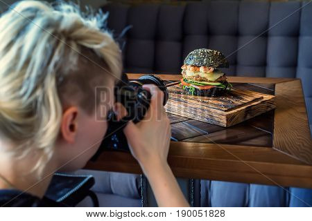 Woman food photographer shoots meal for restaurant