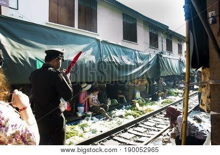 Train Station Staff Pulldown Rail Level Crossing Barriers On Road While Train Arrival At Mae Klong R