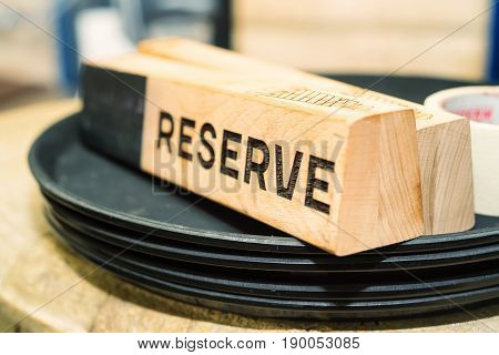 Big table at retaurant served for upcoming banquet with reserved sign