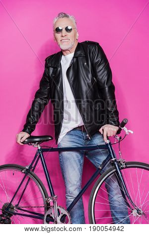 Cheerful Fashionable Senior Man Wearing Leather Jacket And Sunglesses Standing With Bicycle Isolated
