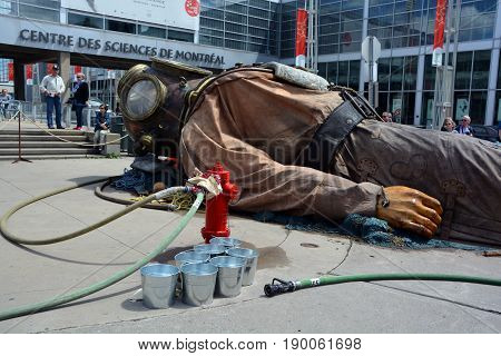 MONTREAL QUEBEC CANADA 19 05 17: The giant deep-sea diver sleeping in the street of Montreal for the 375e anniversary of the city, by Royal De Luxe company Nantes Franc