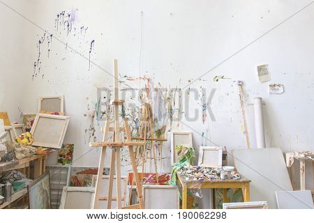 White wall stained with oil paint in the artist's studio interior workshop