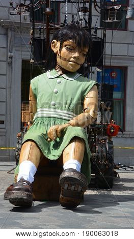 MONTREAL QUEBEC CANADA 19 05 17: The little giant girl sleeping in Place d'arme in old Montreal for the 375e anniversary of the city, by Royal De Luxe company Nantes France
