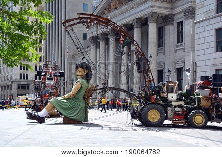 MONTREAL QUEBEC CANADA 19 05 17: The little giant girl sleeping in Place d'arme in old Montreal for the 375e anniversary of the city, by Royal De Luxe company Nantes France