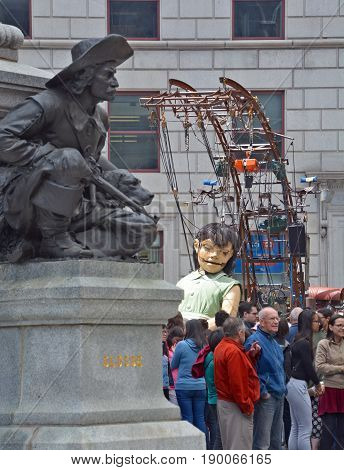 MONTREAL QUEBEC CANADA 19 05 17: The little giant girl sleeping in Place d'arme in old Montreal for the 375e anniversary of the city, by Royal De Luxe company Nantes France
