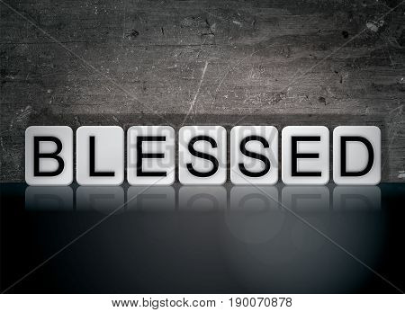 The word Blessed concept and theme written in 3D white tiles on a dark background.