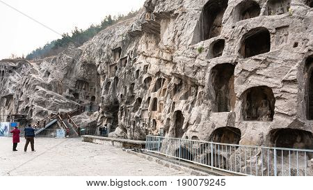 Tourists Near Caves In Slope Of West Hill