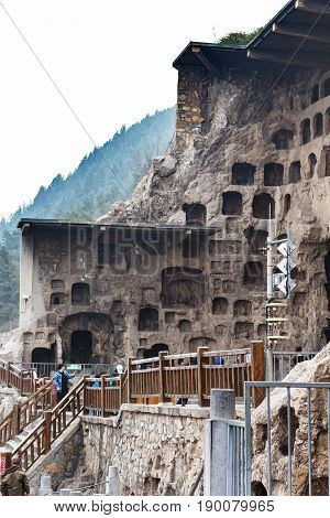People Near Caves In Longmen Grottoes