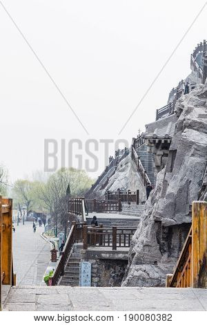 Tourists And Carved Slope In Longmen Grottoes