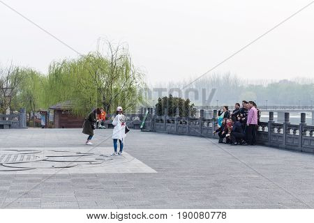 Tourists Take Photo In Longmen Grottoes Area
