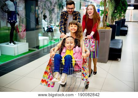 A happy family is shopping together in a mall