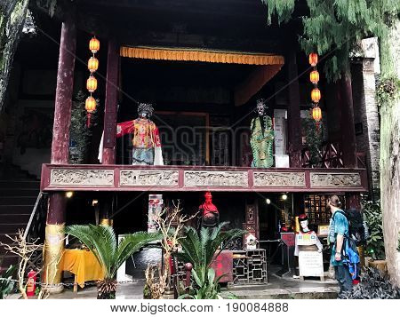 Tourist Near Facade Of Opera Stage In Xingping