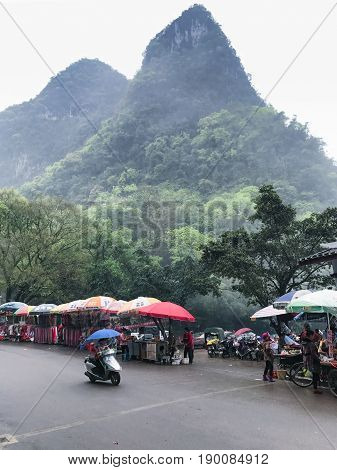 Peole Near Stalls On Outdoor Market In Xingping