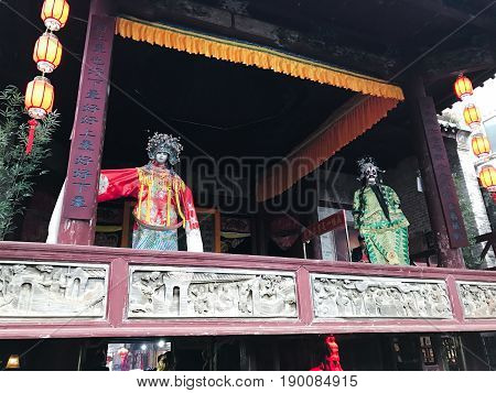 Puppets On Facade Of Opera Stage In Xingping