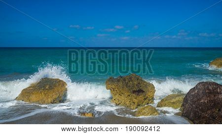 Blue sea landscape with rocks and sea foam