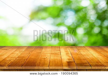 Empty wooden table for product placement or montage with focus to table top in the foreground, with white background. Wooden board empty table perspective.