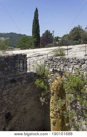 BAGNO VIGNONI, ITALY - JUNE 3 2017: Old thermal baths of Bagno Vignoni in Tuscany Italy free accesible hot spring site