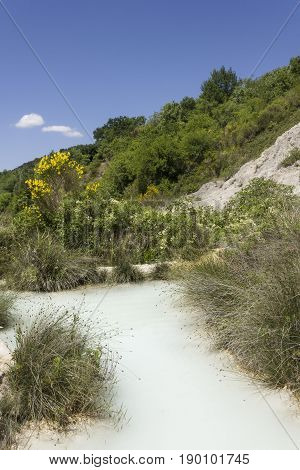 BAGNO VIGNONI, ITALY - JUNE 3 2017: The scenic hot spring pool of Bagno Vignone in Tuscany free accesible area through the nature
