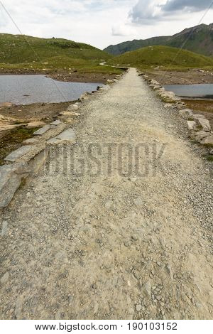 Miners Track Crossing Bridge At Llyn Llydaw On Snowdon.