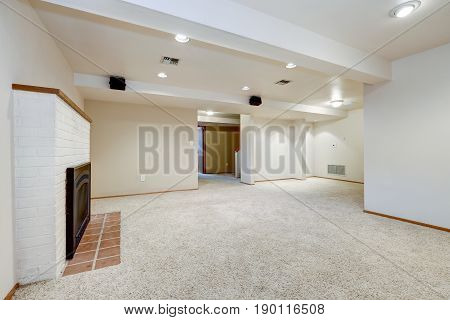 White Empty Basement Room With Fireplace