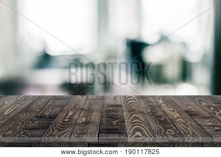 Office wood table perspective on blurred office background. Wood table perspective for design. Wood table surface. Rustic wood table perspective on blurred office background. Large office wood table with blurred back. Wood table texture background. Office