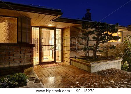 Sunset View Of Front Porch With Paved Walkway