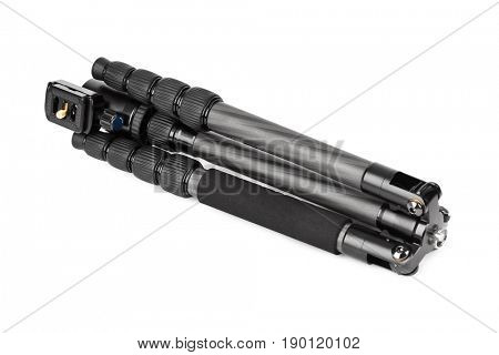 Folded photographic tripod isolated on white background