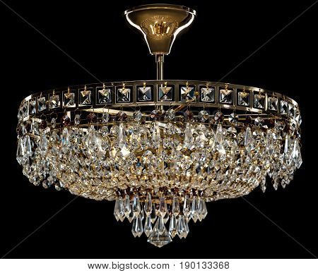 Large crystal chandelier isolated on black background. Luxury royal expensive chandelier for living room, Hall of celebration.
