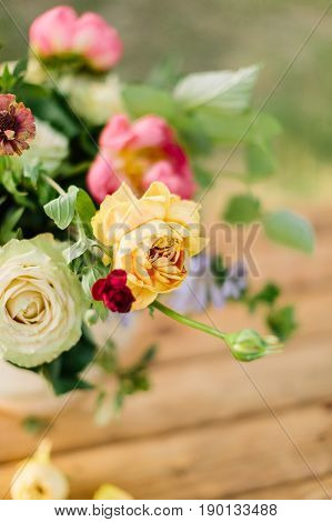 wedding, gardening, floral design, decoration, celebration concept - in beautiful wedding bouquet creamy avalanches and bright yellow roses stand out from other flowers