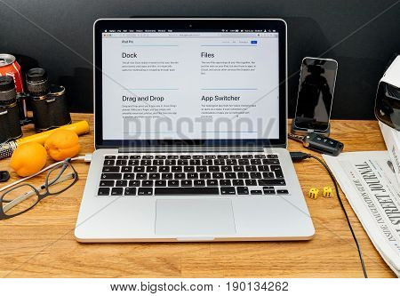 PARIS FRANCE - JUNE 6 2017: Apple Computers website on MacBook Retina in creative environment showcasing latest news from Apple at WWDC 2017 - Dock Apple Files Drag and Drop and App Swither on ios 11 on iPad Pro