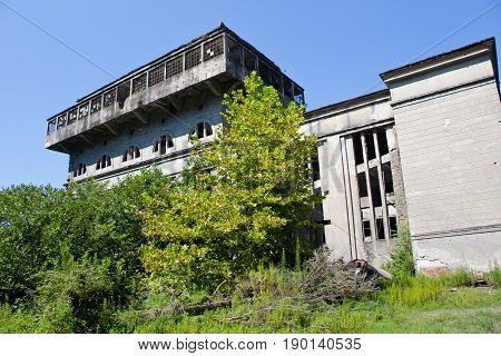 Abandoned overgrown ruins of destroyed by war Tkvarcheli (Tquarhcal) power plant, Abkhazia, Georgia