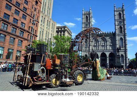 MONTREAL QUEBEC CANADA 19 05 17: The little giant girl walking in the street of Montreal for the 375e anniversary of the city, by Royal De Luxe company Nantes France