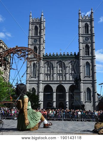 MONTREAL QUEBEC CANADA 19 05 17: The little giant girl walking in the street of Montreal for the 375e anniversary of the city, by Royal De Luxe company Nantes France