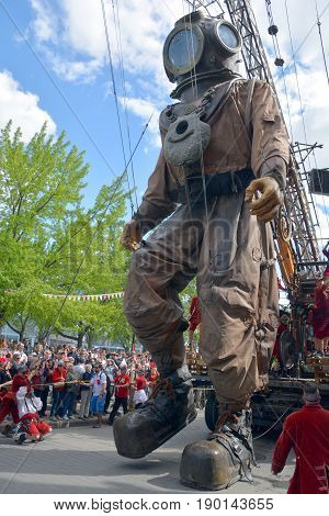 MONTREAL QUEBEC CANADA 19 05 17: The giant deep-sea diver in the street of Montreal for the 375e anniversary of the city, by Royal De Luxe company Nantes France