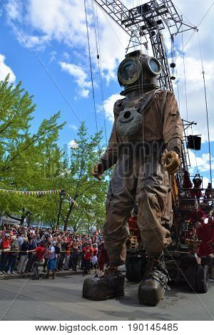 MONTREAL QUEBEC CANADA 19 05 17: The giant deep-sea diver sleeping in the street of Montreal for the 375e anniversary of the city, by Royal De Luxe company Nantes France