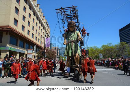 MONTREAL QUEBEC CANADA 19 05 17: The little giant girl walking in the street of Montreal for the 375e anniversary of the city, by Royal De Luxe company Nantes France