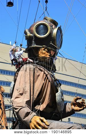 MONTREAL QUEBEC CANADA 19 05 17: The giant deep-sea diver sleeping in the street of Montreal for the 375e anniversary of the city, by Royal De Luxe company Nantes France