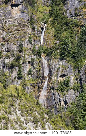 Beautiful mountain landscape in Himalayas Annapurna region Nepal. Sunny day of Nepal summer. Big mountain waterfall and fresh air. Eco travel