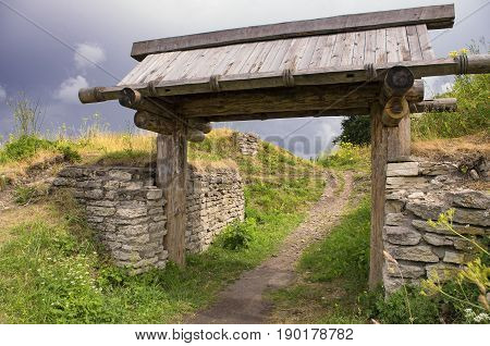 The wooden gate in the ancient Truvor's settlement in cloudy weather (Pskov Oblast).