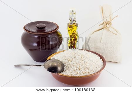 The Composition Of Rice Groats In A Clay Pial Next To A Clay Pot And A Copper Spoon,
