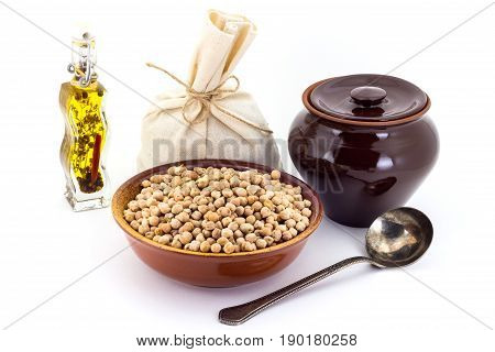The Composition Of Chick Peas In A Clay Pial Next To A Clay Pot And A Copper Spoon,