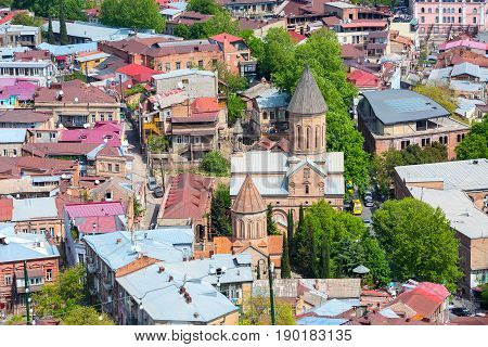 Tbilisi, Republic of Georgia - April 29, 2017: Aerial view with traditional georgian houses and church in Old Town of Tbilisi, Republic of Georgia