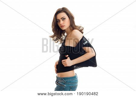 sexy young girl in a black t-shirt and shorts posing on camera isolated on white background