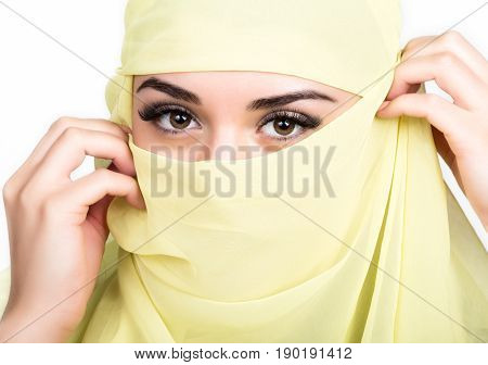 Closeup of beautiful young arabian woman in yellow hijab. Charm and beauty of the East