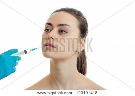 horizontal portre young beautiful girl at the doctor with syringe is isolated on a white background close-up